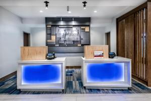 a lobby with two reception desks and a television at Holiday Inn Express & Suites Round Rock Austin North, an IHG Hotel in Round Rock