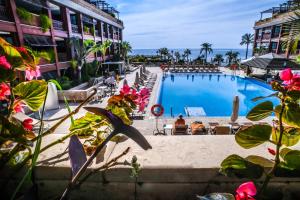 a large swimming pool next to a building at Gran Hotel Guadalpín Banus in Marbella
