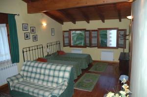 a bedroom with two beds and a couch at Casa Rural El Colorao in Sotés +24 photos