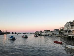 a group of boats in the water near houses at Cliff Lodge in Nantucket
