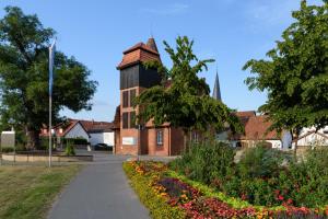 an old brick building with a water tower at Hotel Stadt Lügde in Lügde