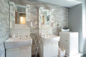 a white bathroom with two sinks and a mirror at Sakono building / Vacation STAY 7312 in Fukuoka