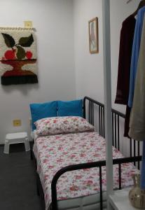 a bedroom with a bed with a floral bedspread at Rezi in Slap ob Idrijci