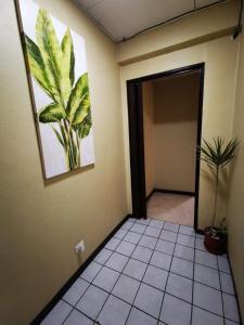 a room with a painting of a plant on the wall at Toucan Hostel in Alajuela City