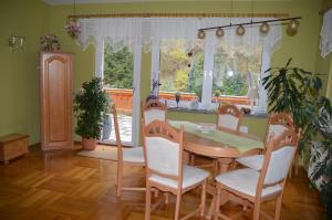 a dining room with a table and chairs and a window at Ferienhaus Linde am Bleßberg in Schirnrod