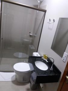 a bathroom with a toilet and a sink and a shower at Sleep Hotel in Toledo