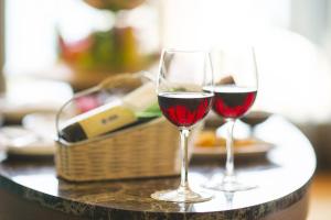 two glasses of red wine sitting on a table at Hotel Club Maria Sidari in Sidari