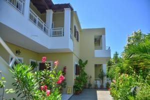a view of the outside of a house with flowers at Hotel Club Maria Sidari in Sidari