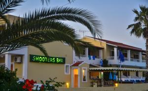a building with a sign that reads shoot fees bar at Hotel Club Maria Sidari in Sidari