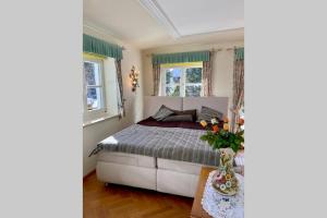 um quarto com uma cama e duas janelas em Apartment Linda em Abtenau