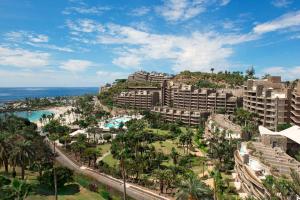 een luchtzicht op een resort met palmbomen en de oceaan bij Anfi del Mar 1 in La Playa de Arguineguín