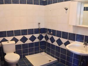 a bathroom with a toilet and a sink at Hotel Club Maria Sidari in Sidari