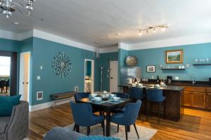 a living room with blue walls and a table and chairs at 3rd Street Flats in McMinnville