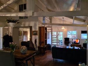 a living room with a table and a couch at Natuurhuis de LandJonker in Geesteren