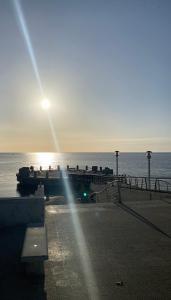 a pier with the sun rising over the water at B&B Shining in Avola