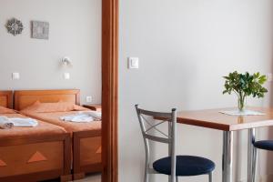 a bedroom with a bed and a table and a chair at Hotel Club Maria Sidari in Sidari