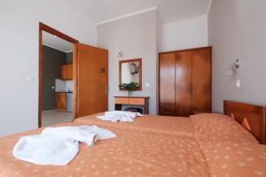 a bedroom with a bed with two towels on it at Hotel Club Maria Sidari in Sidari
