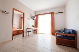 a living room with a table and a window at Hotel Club Maria Sidari in Sidari
