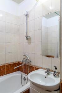 a bathroom with a sink and a toilet and a mirror at 112 вулиця Велика Васильківська in Kyiv
