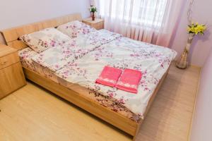 a bedroom with a bed with two books on it at 112 вулиця Велика Васильківська in Kyiv