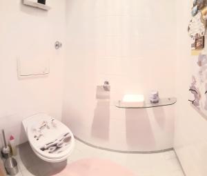 a white bathroom with a toilet and a sink at bedroom@home in Berg bei Rohrbach