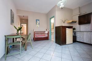 a kitchen with a table and a dining room at Hotel Club Maria Sidari in Sidari