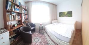 a small bedroom with a bed and a book shelf at bedroom@home in Berg bei Rohrbach