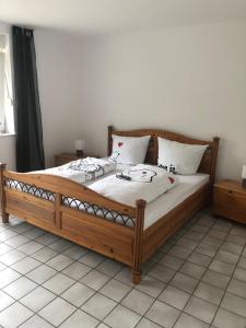 a wooden bed in a room with two pillows on it at Rüsgen Ferienwohnung in Schwalmtal
