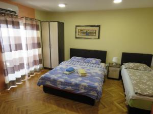 a small bedroom with a bed at Hotel Apartments Bella Mare Belgrade in Belgrade
