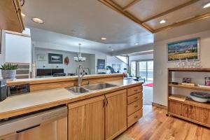 a large kitchen with wooden cabinets and a sink at 2 Mi to Park City Mtn Townhome with Balcony in Park City