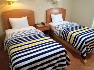 Postel nebo postele na pokoji v ubytování Hotel Florencia Regency