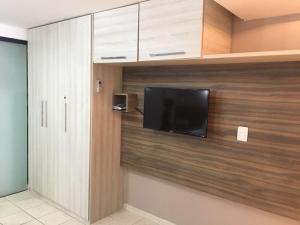 a room with a flat screen tv on a wall at Atlântico Flat 110 in Natal