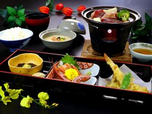 a tray filled with different types of food on a table at Nomoto Ryokan Matsunoyama Onsen in Tokamachi