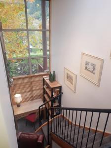 a room with a staircase with a window and a desk at Villa 10 - Central Stylish Apartment in Queenstown