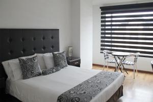 Postel nebo postele na pokoji v ubytování Hotel Santafe Real