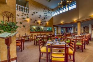 a dining room with wooden tables and chairs at Buena Vista Chic Hotel in Alajuela