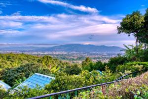 a view of a city from the top of a hill at Buena Vista Chic Hotel in Alajuela City