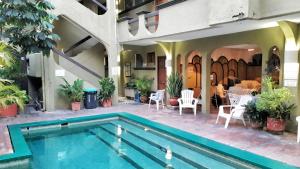 a house with a swimming pool and a restaurant at Solimar Inn Suites in Zihuatanejo