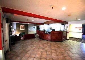 a large room with a bar in a restaurant at Norwood Inn and Suites - Roseville in Roseville