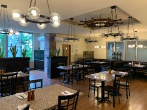 a dining room at a restaurant with tables and chairs at West Plaza Hotel at Lebuu Street in Koror