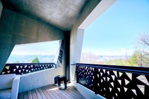 a balcony of a house with a large window at HOTEL KEYFOREST HOKUTO in Hokuto