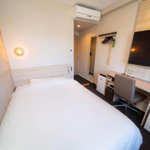 Postel nebo postele na pokoji v ubytování Super Hotel Nagaizumi Numazu Inter