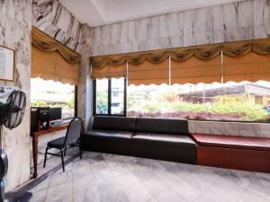 a waiting room with a bench in front of a window at Grand Supreme Hotel in Kuching