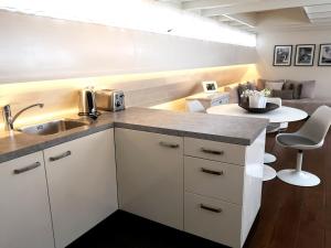 a kitchen with a sink and a table in a room at Prince Royal B&B in Amsterdam