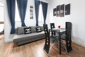 a living room with a couch and a table at Apartamentos Day Madrid GRAN VIA Centro Sol Malasaña in Madrid