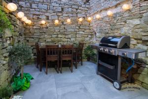 a patio with a grill and a table and chairs at Casa Da Ponte in Koper