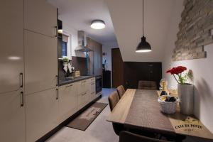 a kitchen and dining room with a wooden table at Casa Da Ponte in Koper