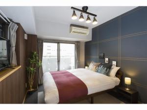 מיטה או מיטות בחדר ב-Coruscant Hotel Nagasakieki