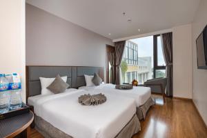 Un ou plusieurs lits dans un hébergement de l'établissement DTX Hotel Nha Trang