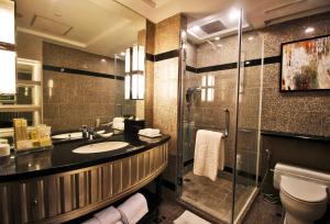 a bathroom with a sink and a shower at Diamond Hotel Philippines in Manila